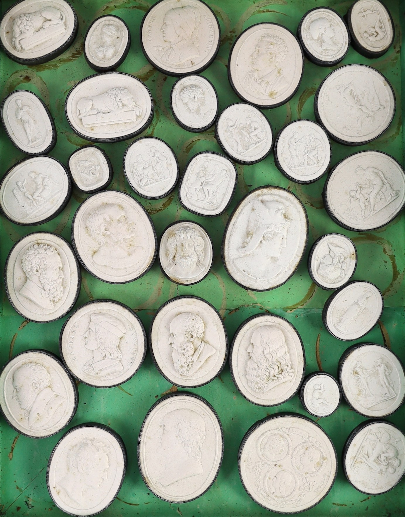 A cased set of eighty three Italian Grand Tour plaster roundels after intaglios of various subjects, box 29 x 22.5cm, largest cameo 5 x 4cm